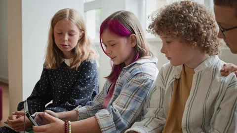 Schoolchildren Using Digital Tablet for Interactive Learning Stock Footage 345225461
