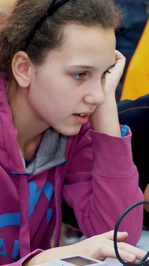 Schoolchildren working together on a laptop in computer class, typing on a Stock Footage 315093602