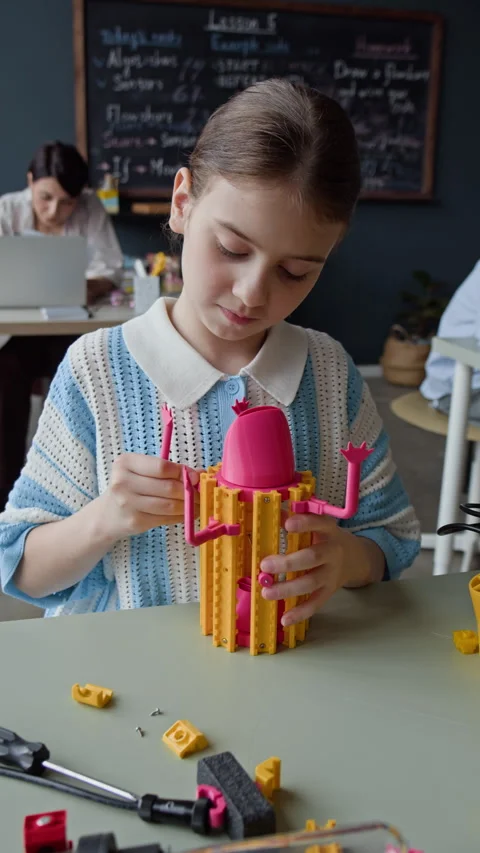 Schoolgirl Assembling Toy Robot in Elementary School Stem Class Stock Footage 339195341
