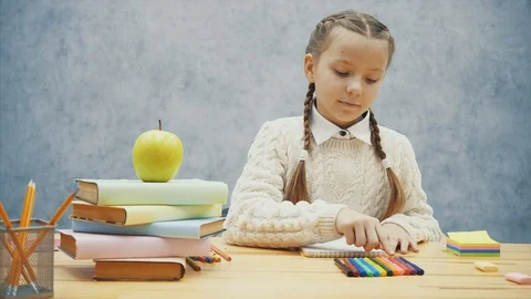 Schoolgirl chooses red highlighter, opens it and starts drawing. Stock Footage 113071237