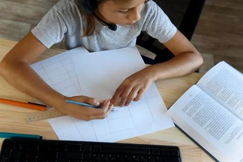 Schoolgirl does lessons in front of the computer Stock Photos