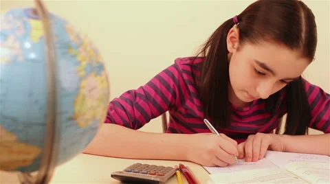 Schoolgirl doing her homework 스톡 동영상 47028320