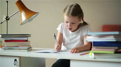 Schoolgirl doing homework and preparing for exams, cute children learning her Stock Footage 64164599