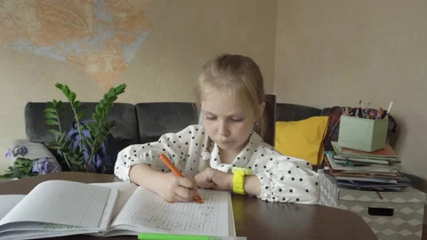 Schoolgirl doing homework Stock Footage 154420544
