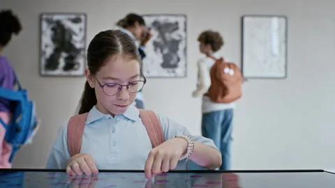Schoolgirl Interacting with Digital Touch Screen in Museum Gallery Stock Footage 343610420