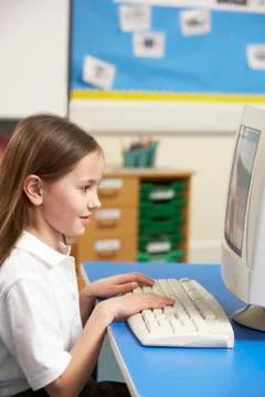 Schoolgirl In IT Class Using Computer Stockfoto's