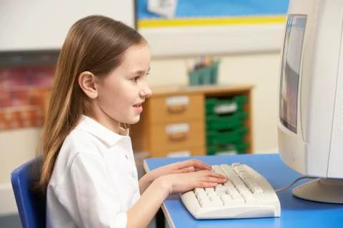 Schoolgirl In IT Class Using Computer 스톡 사진
