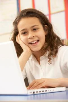 Schoolgirl In IT Class Using Computer Stockfoto's