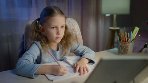 Schoolgirl Junior School Does Homework In The Evening Stock Footage 149957730