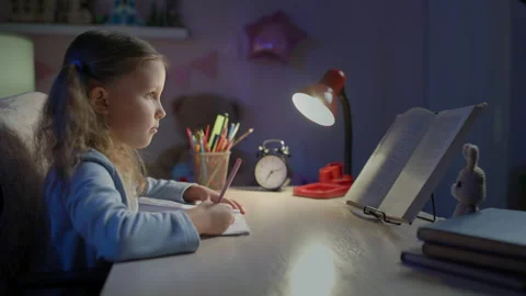 Schoolgirl Junior School Does Homework In The Evening Stock Footage 149964237