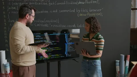 Schoolgirl Presenting Coding Project on Screen and Debating with Teacher Stock Footage 318718307