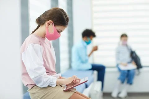 Schoolgirl In Queue To Doctor's Office Stock Photos