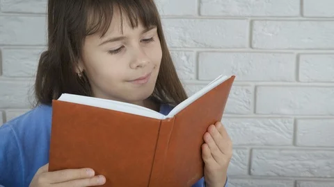 Schoolgirl is reading. Stock Footage 103224720