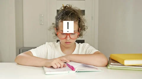 Schoolgirl solved a difficult task while doing homework. Girl is pleased with Stock Footage 135136487