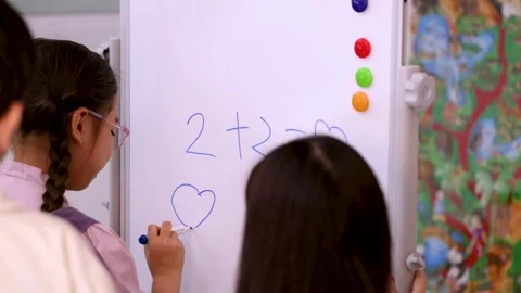 Schoolgirl Solving Simple Math Problem on Classroom Whiteboard Stock Footage 330995658