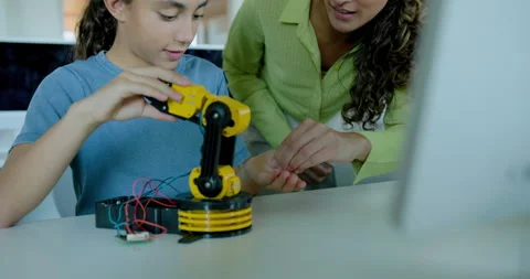 Schoolgirl in STEM Computer Classroom, Looking at Robot arm with Teacher Stock Footage 286091246