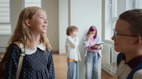 Schoolgirl Talking to Classmate in School Corridor during Break Stock Footage 345224025