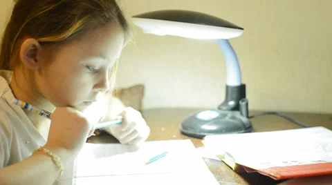 Schoolgirl thinks on homework Stock Footage 35848252