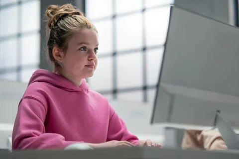 Schoolgirl using computer in classroom at school Stock Photos