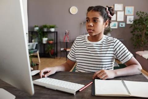 Schoolgirl using computer for study Stock Photos