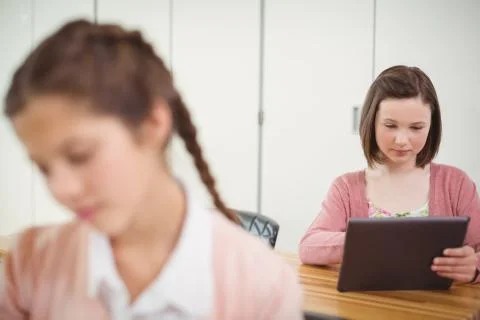 Schoolgirl using digital tablet in classroom 스톡 사진