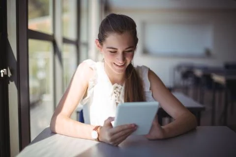 Schoolgirl using digital tablet in classroom Stock Photos