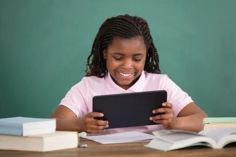 Schoolgirl Using Digital Tablet 스톡 사진