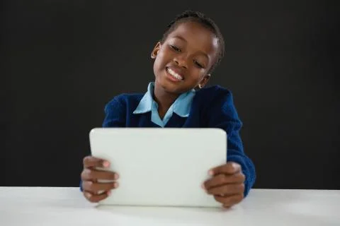 Schoolgirl using digital tablet 스톡 사진