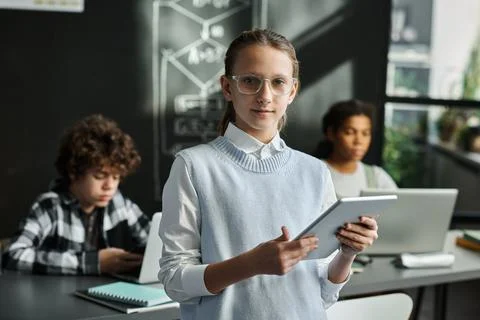 Schoolgirl using gadgets at study Stock Photos