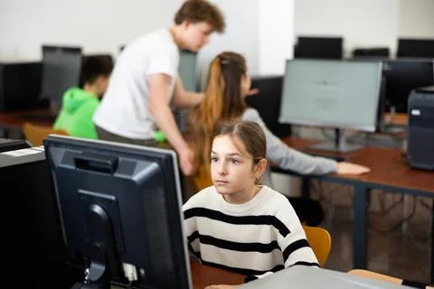 Schoolgirl using PC during computer science lesson 写真素材