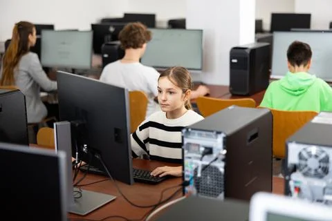 Schoolgirl using PC during computer science lesson Stock Photos