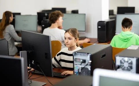 Schoolgirl using PC during computer science lesson 스톡 사진