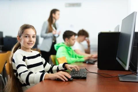 Schoolgirl using PC during computer science lesson 스톡 사진