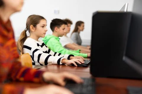 Schoolgirl using PC during computer science lesson Stock Photos