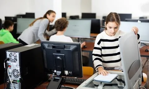 Schoolgirl using printer during computer science lesson Stock Photos