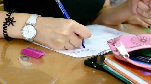 Schoolgirl writes the task in a notebook Stock Footage 62321142