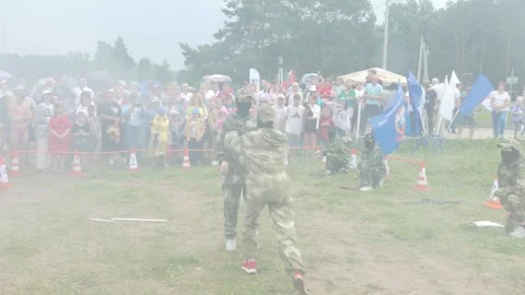 Schoolgirls demonstrate elements of military training in the smoke. Stock Footage 247007084