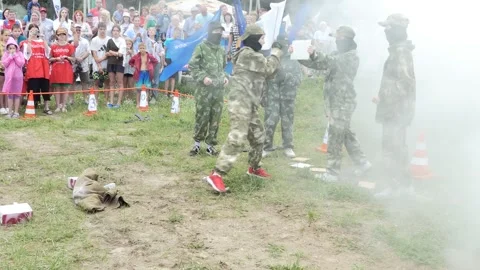 Schoolgirls demonstrate elements of military training in the smoke. Stock Footage 247007250