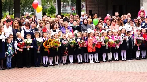 Schoolgirls of primary classes stand on the line in the day of knowledge Stock Footage 73833738