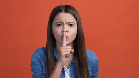 Schoolkid ask not share rumor caution finger isolated crimson color background Video stock 166900579