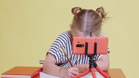 Schoolkid doing exercises at the desk using pencils Stock Footage 138447134