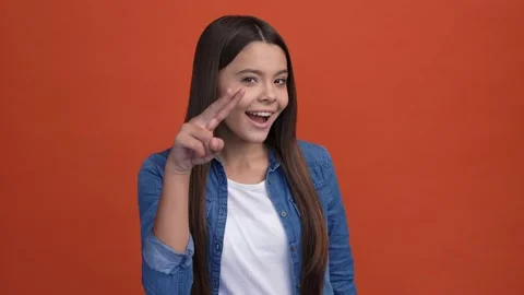 Schoolkid fool point two fingers see you eye isolated scarlet color background Stock Footage 166900478