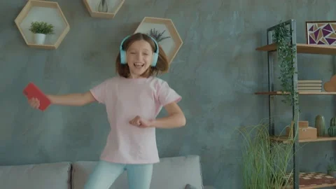 Schoolkid listen dynamic melody headset gadget jump couch in room flat Stock Footage 166678796