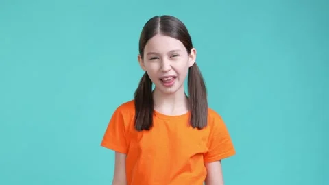 Schoolkid make different faces isolated cyan color background Stock Footage 190178340