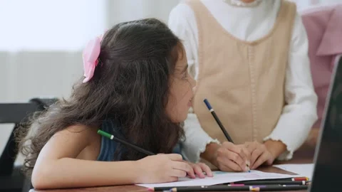 Schoolkid writing in notebook during lesson in classroom. Back to school concept Vídeos de archivo 249832672
