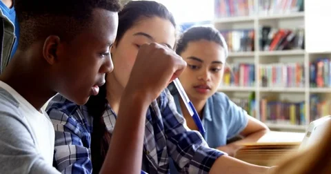 Schoolkids using digital tablet in library 4k Видео 82228398