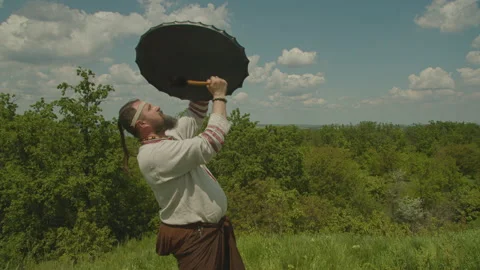 A schuman man plays a shamanic drum, tries to make it rain, worship the old gods Stock Footage 155199861