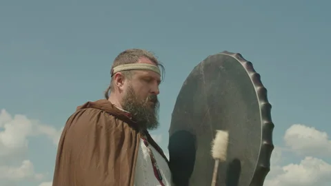 A schuman man plays a shamanic drum, tries to make it rain, worship the old gods Stock Footage 155299467