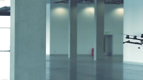 Sci-fi drone octocopter in slow motion surveying office interior Stock Footage 106393064