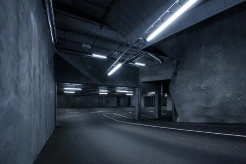 Sci fi looking dark and moody underground parking lot with fluorescent lights Stock Photos